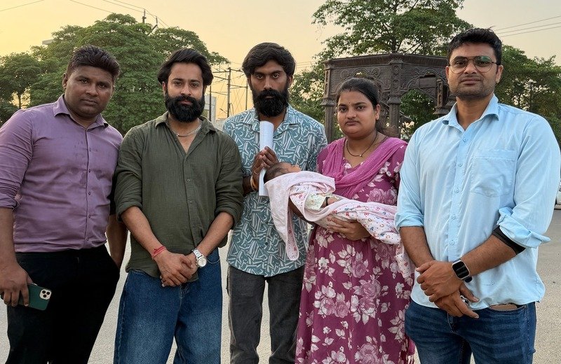 Founder and volunteers supporting a family with newborn infant medical care